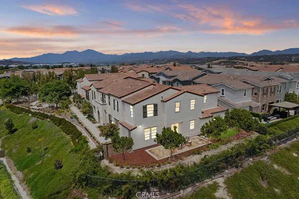 an aerial view of residential houses with outdoor space and a lake view