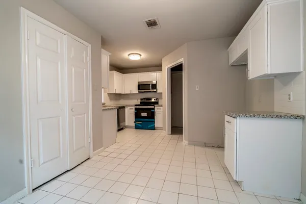 a view of a kitchen with electric appliances