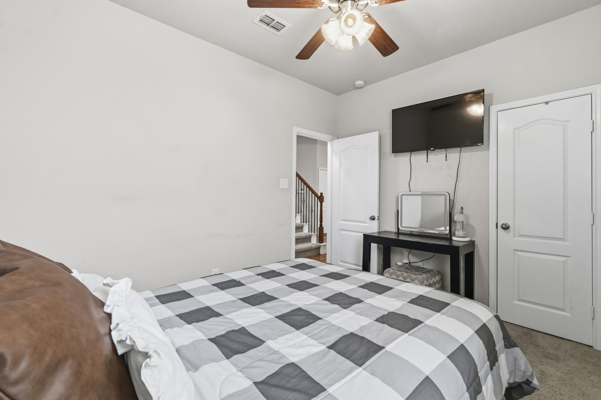 3900 Enchanted Timbers Lane Spring, TX 77386 - Photo 25 of 49 a bedroom with a bed and a flat screen tv
