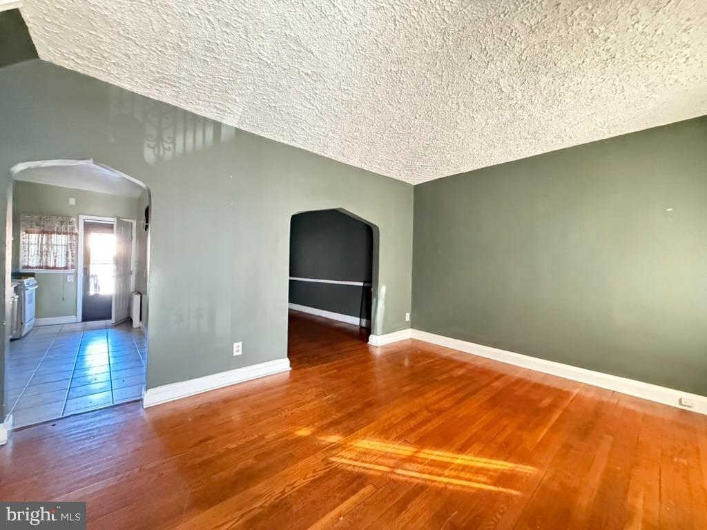 3823 Cottage Avenue Baltimore, MD 21215 - Photo 2 of 3 a view of an empty room with wooden floor