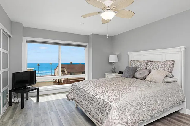 a bedroom with a bed and a large window with outer view