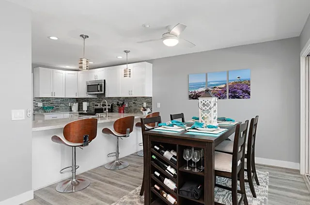 a kitchen with granite countertop a dining table chairs and a dining table