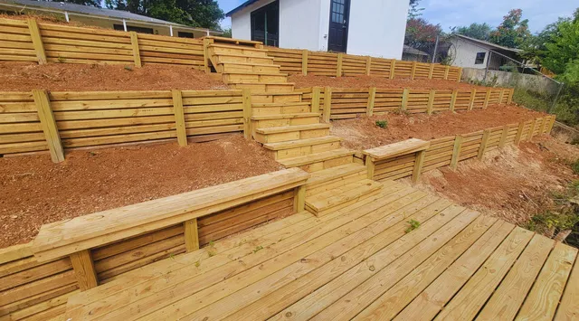 a view of a balcony with wooden floor and a potted plant