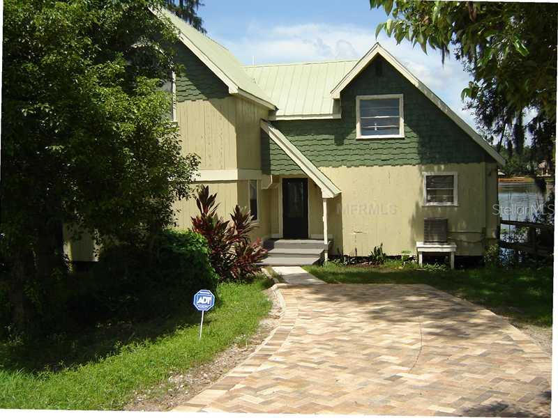 8111 North Mobley Road Odessa, FL 33556 - Photo 1 of 1 a front view of a house with garden