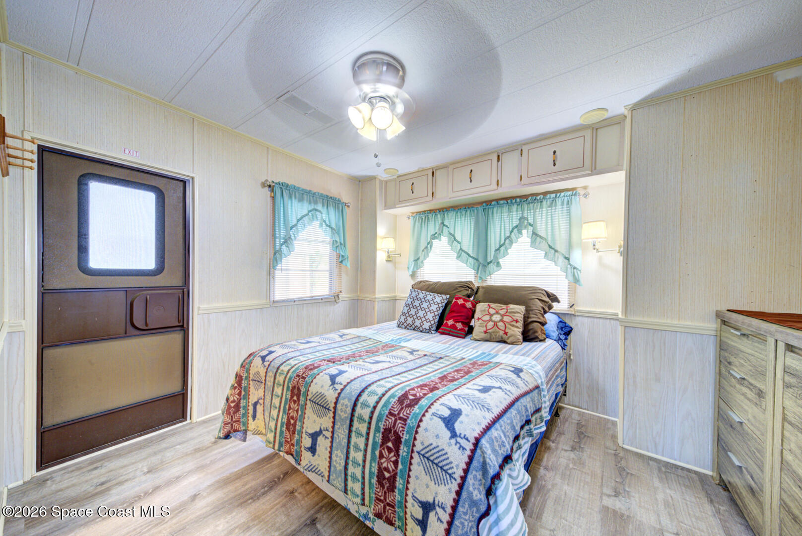 283 Buffalo Place Rockledge, FL 32955 - Photo 21 of 23 a bedroom with a bed and a chandelier