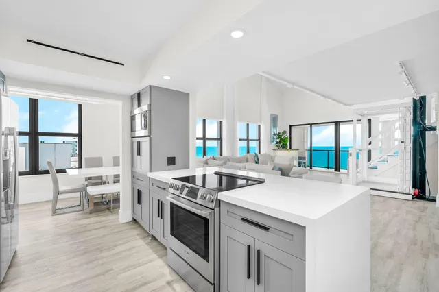 a kitchen with stainless steel appliances granite countertop a sink stove and cabinets