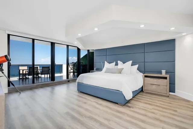 a bedroom with furniture and a flat screen tv