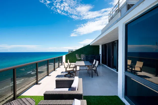 a view of a swimming pool with lawn chairs