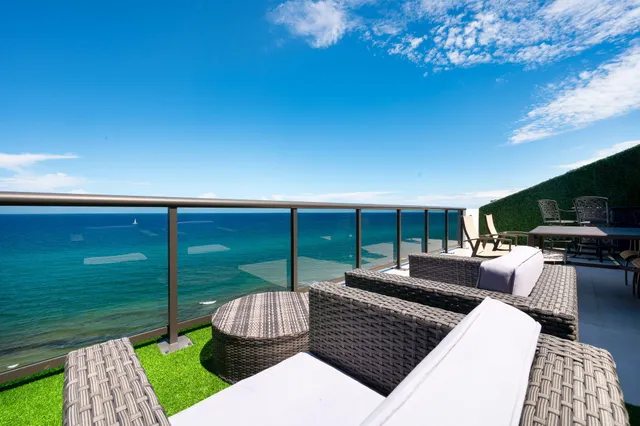 a hallway with white cabinets and wooden floor