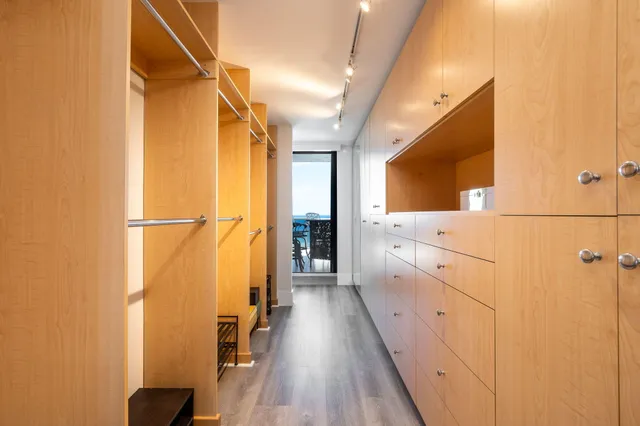 a large bathroom with a double vanity sink a large mirror and a bathtub