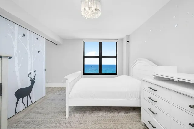 an empty room with wooden floor and a window