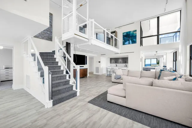 a living room with furniture a fireplace and wooden floor