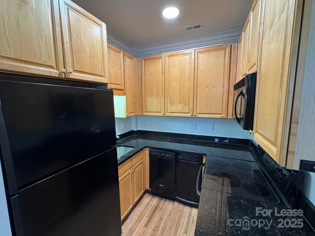 a kitchen with a sink a refrigerator and window