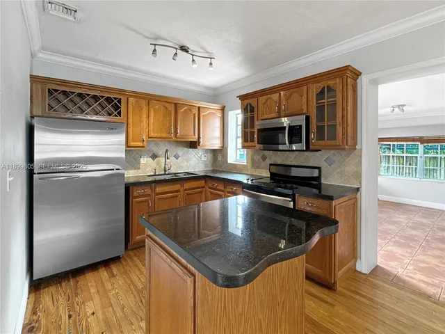 a kitchen with a sink stove and microwave