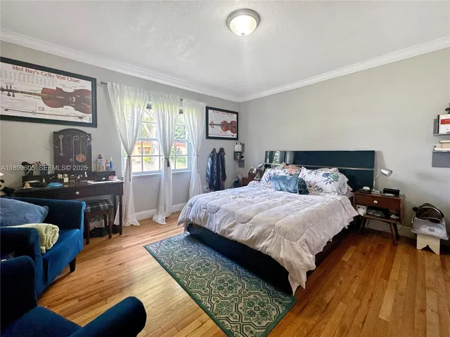 a bed room with a bed and a chair