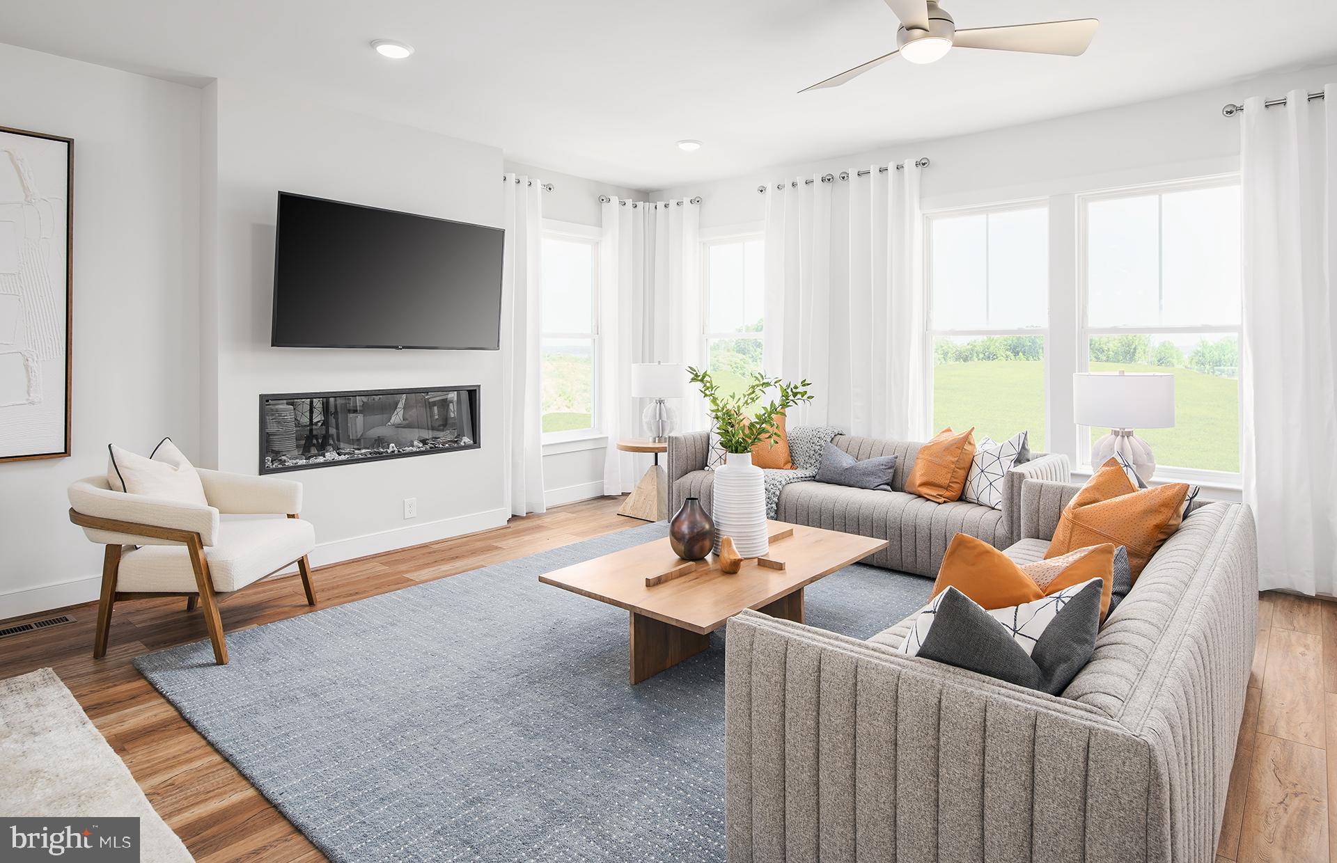 303 Backwater Way Laurel, MD 20724 - Photo 9 of 33 a living room with furniture a flat screen tv and a large window