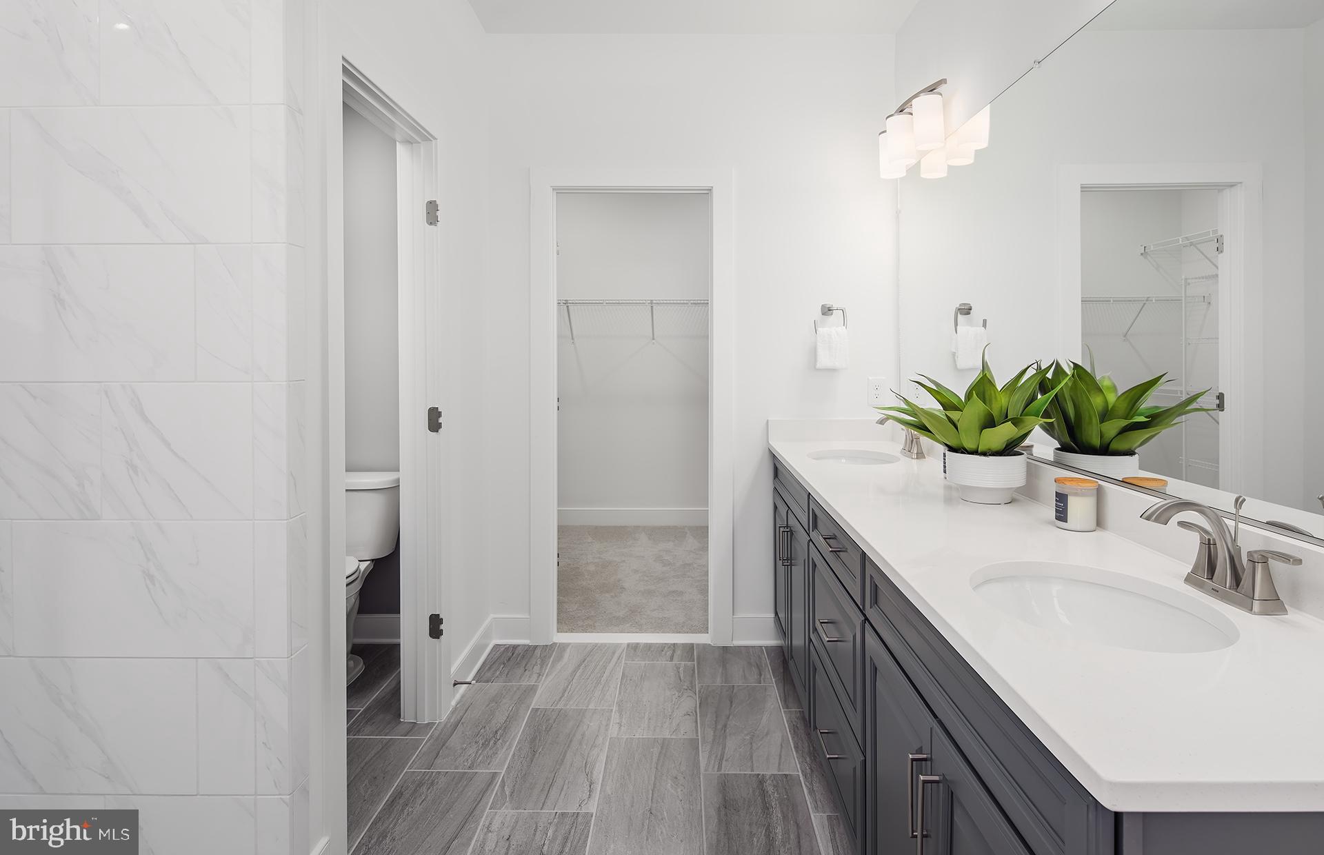 303 Backwater Way Laurel, MD 20724 - Photo 12 of 33 a bathroom with a granite countertop sink a mirror and a shower