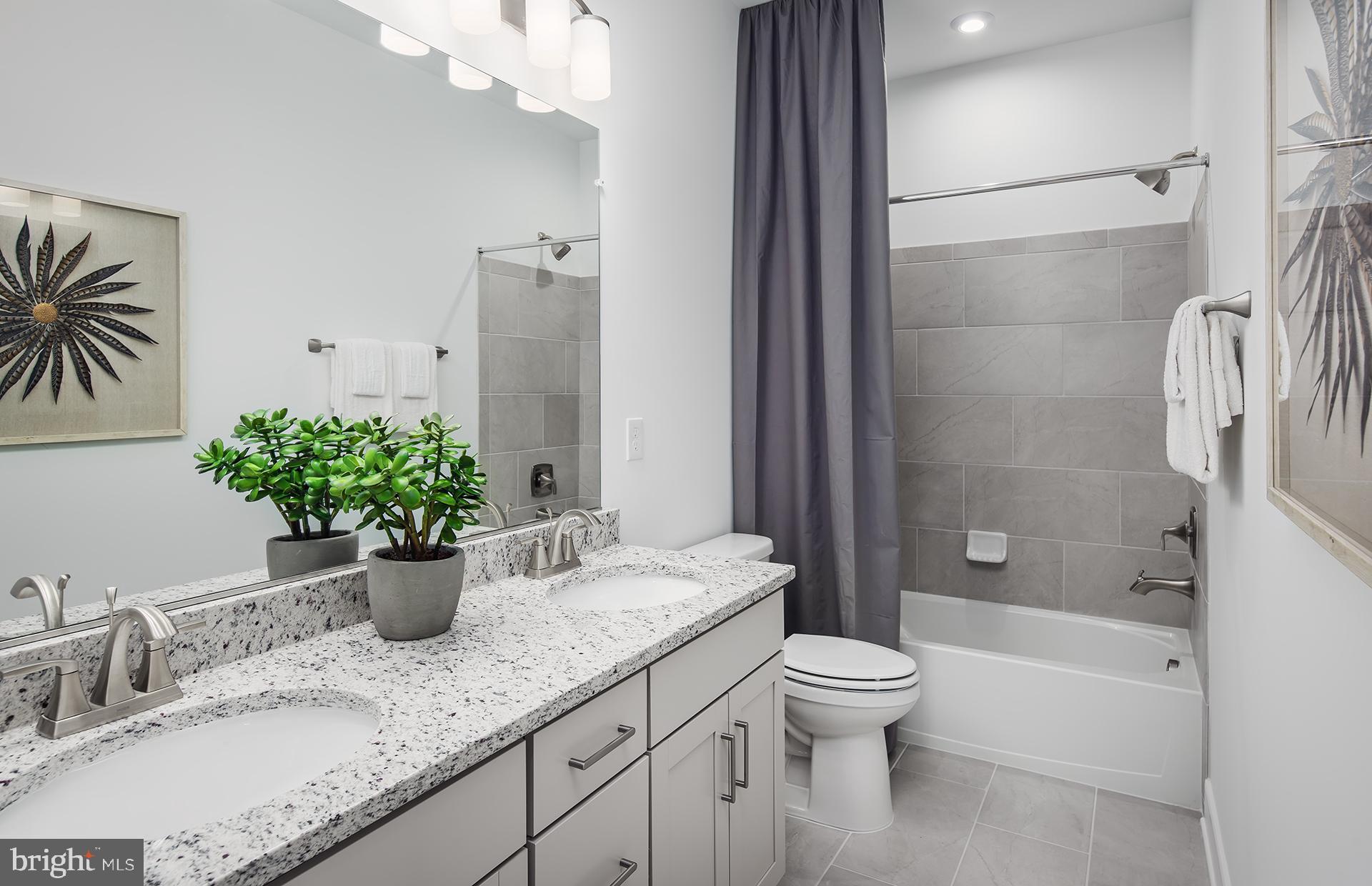 303 Backwater Way Laurel, MD 20724 - Photo 15 of 33 a bathroom with a granite countertop sink a toilet and shower