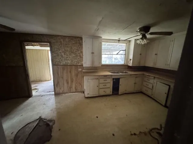 a kitchen with a sink stainless steel appliances and cabinets