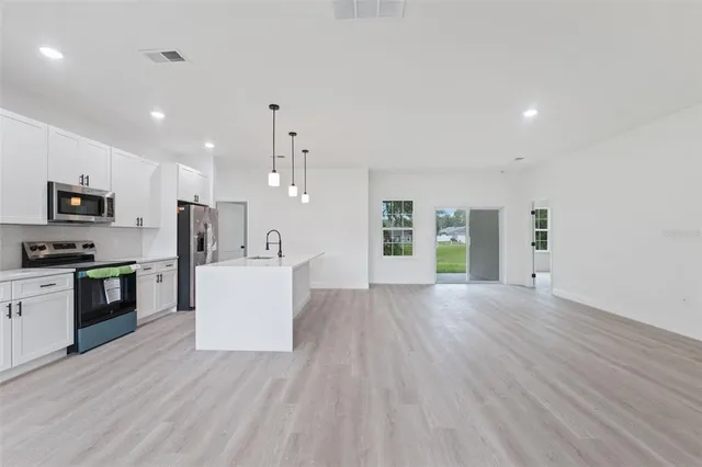 a view of kitchen with cabinets and wooden floor