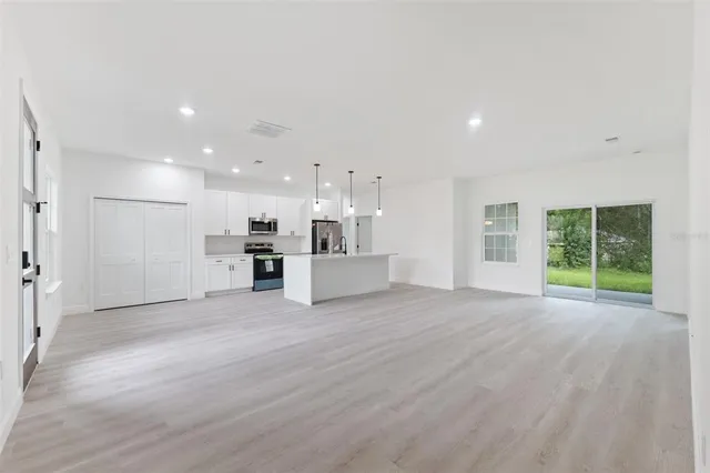 a view of a kitchen with a sink and a window