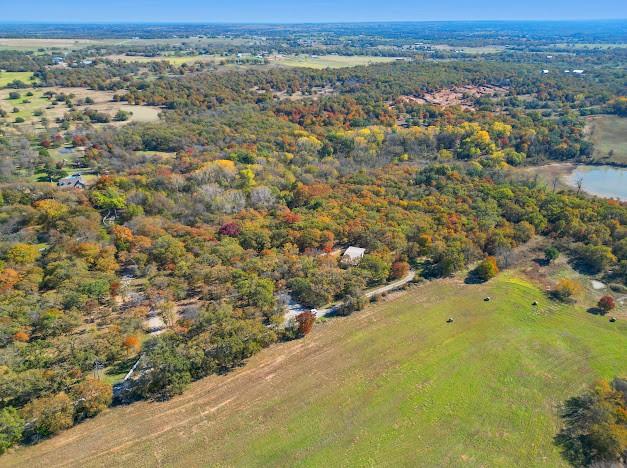 1625 Sanger Drive Springtown, TX 76082 - Photo 40 of 40 Sanger Drive dead end. The road stops where it appears to run into the trees. Enter this property through the gate just to the left of the workshop. Conservation lake on adjacent property on right in photo.
