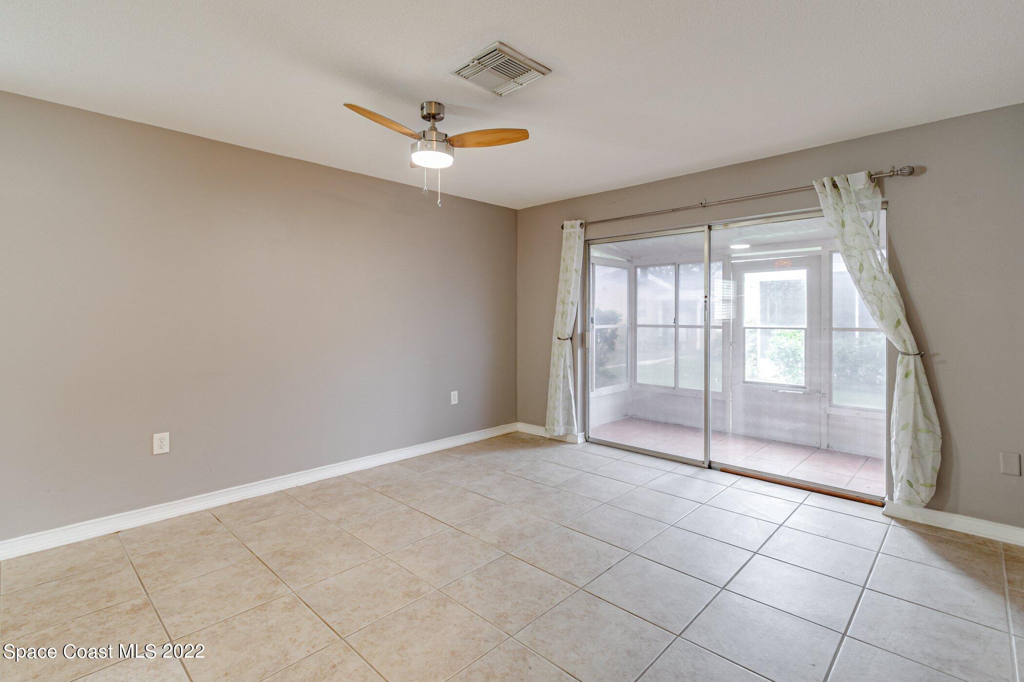 714 Catalina Road, Unit 9 Cocoa Beach, FL 32931 - Photo 11 of 33 a view of an empty room with glass door