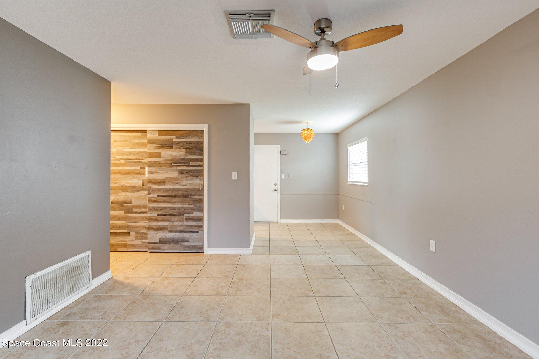 714 Catalina Road, Unit 9 Cocoa Beach, FL 32931 - Photo 12 of 33 an empty room with windows and fan