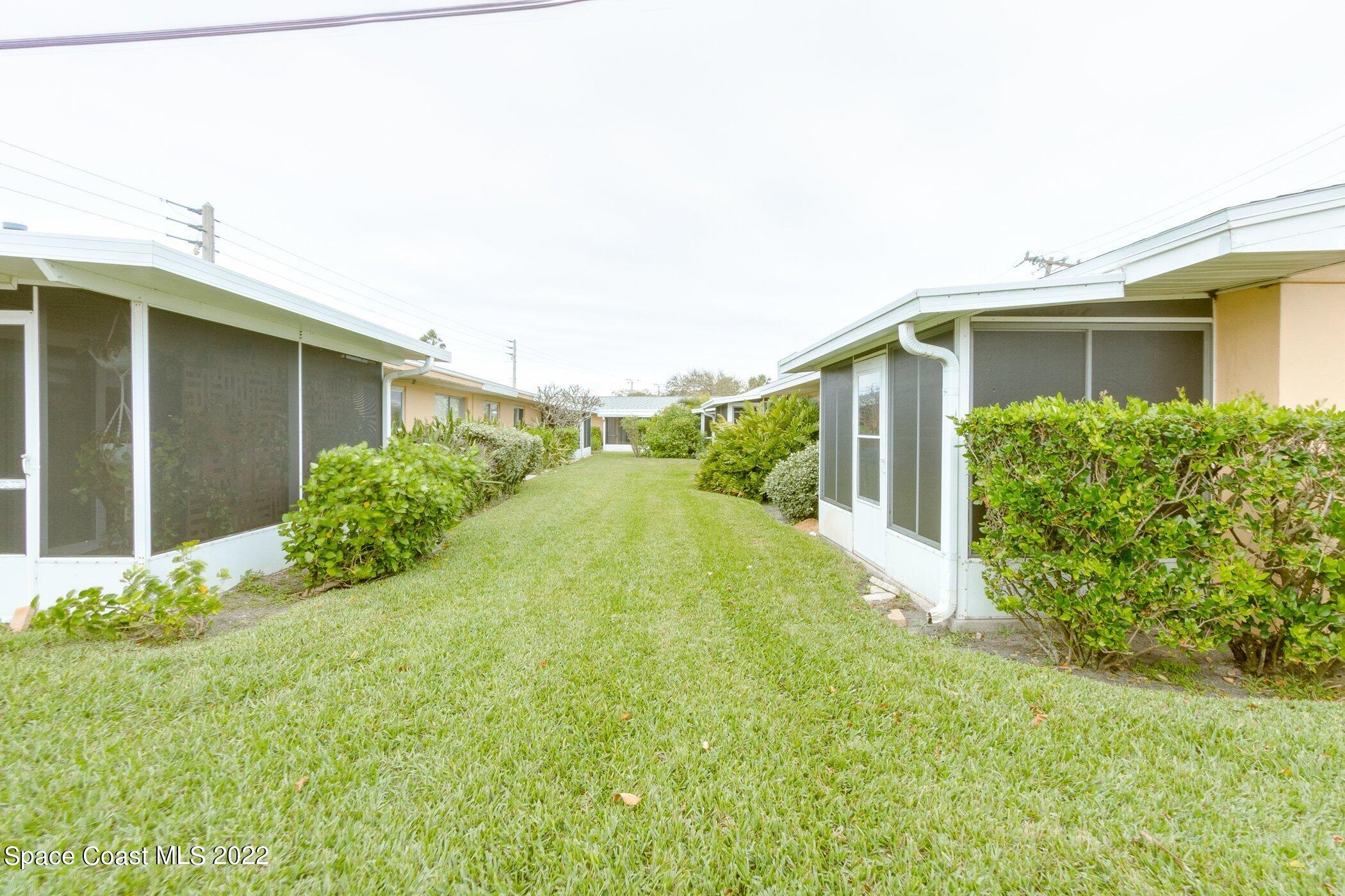 714 Catalina Road, Unit 9 Cocoa Beach, FL 32931 - Photo 28 of 33 a view of a back yard of the house