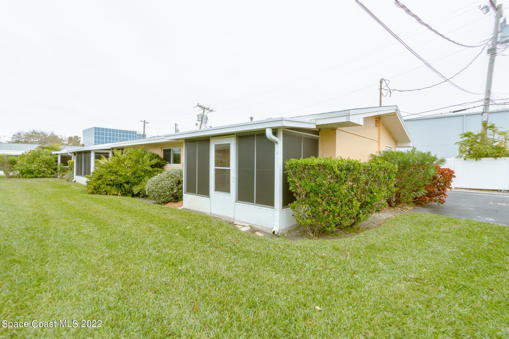 714 Catalina Road, Unit 9 Cocoa Beach, FL 32931 - Photo 3 of 33 a front view of a house with garden