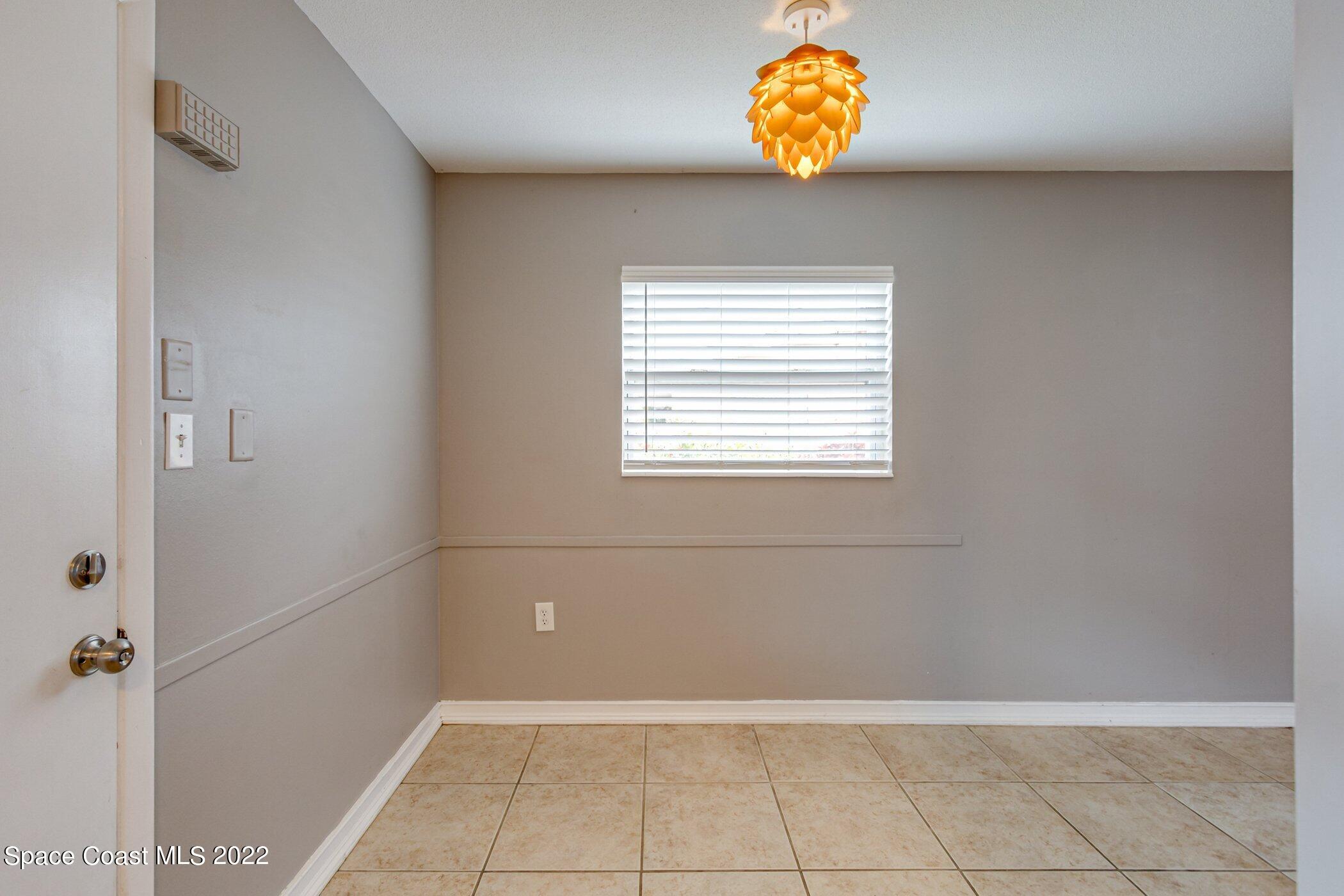 714 Catalina Road, Unit 9 Cocoa Beach, FL 32931 - Photo 8 of 33 a bathroom with a window and a shower