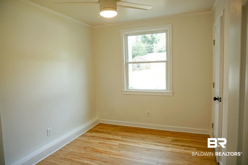 4667 Cottonwood Drive Mobile, AL 36608 - Photo 17 of 21 Spare room with a healthy amount of sunlight, light hardwood / wood-style floors, and ornamental molding