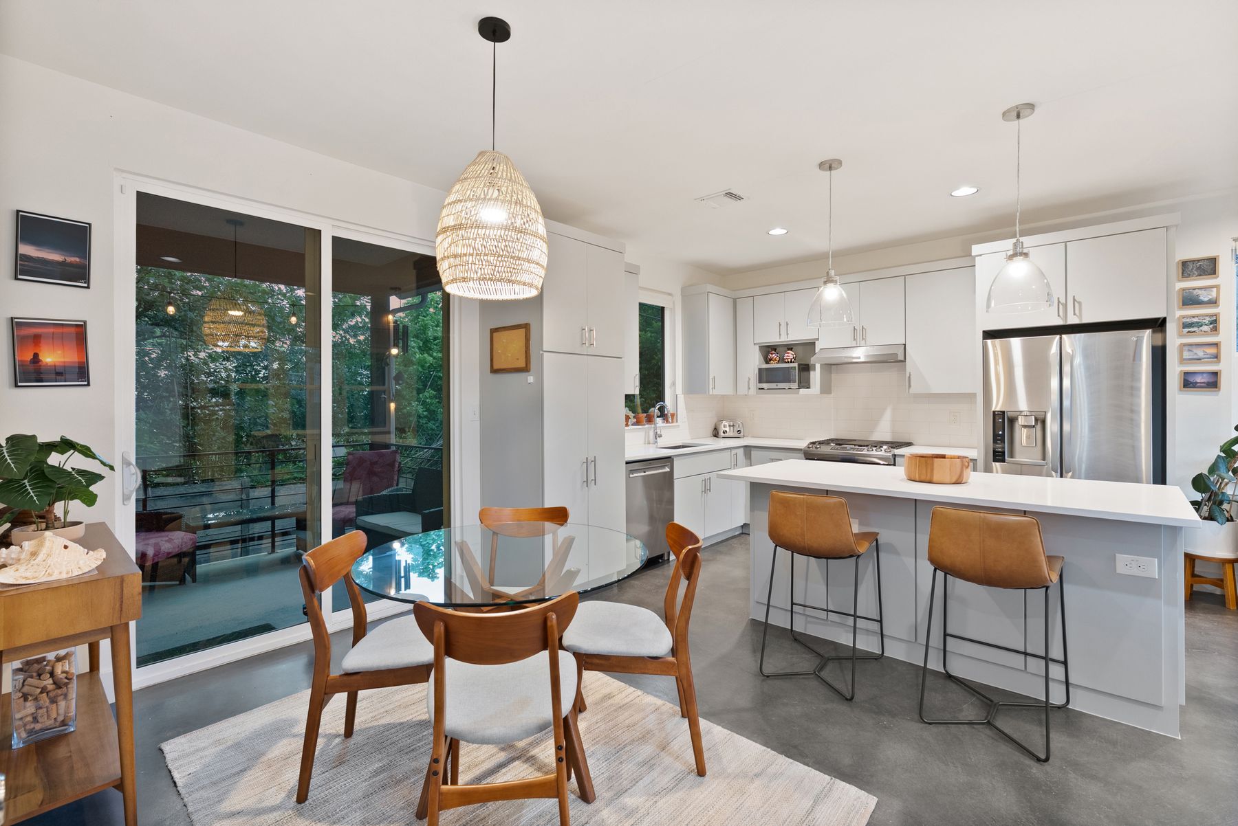 1709 Perez Street, Unit 2 Austin, TX 78721 - Photo 15 of 33 A sleek, contemporary kitchen boasts stainless steel appliances, a generous island with seating, and seamless access to an outdoor living space.