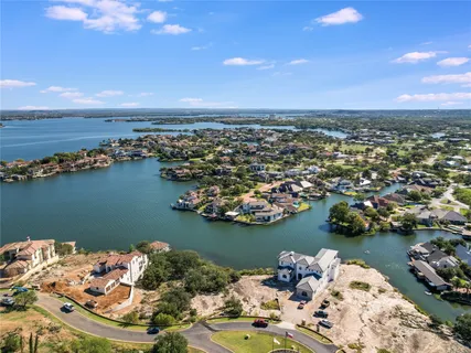 a car parked in front of a house with large trees
