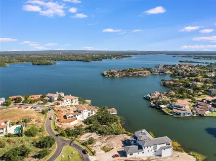 an aerial view of a houses with ocean view