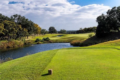 an aerial view of a house with swimming pool and garden