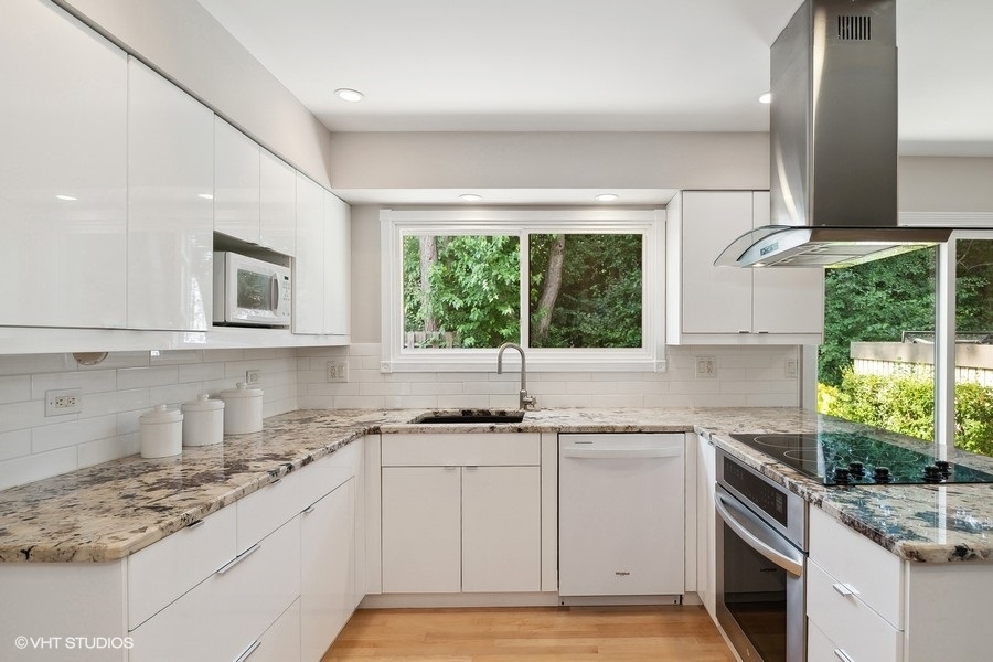 103 Viola Court Rolling Meadows, IL 60008 - Photo 11 of 27 a kitchen with a sink stove and cabinets