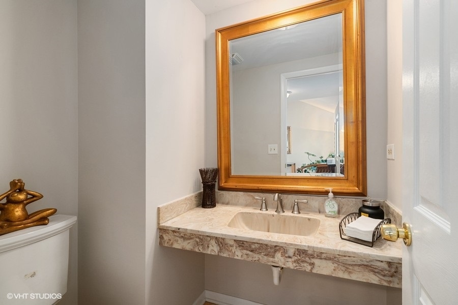 103 Viola Court Rolling Meadows, IL 60008 - Photo 14 of 27 a bathroom with a granite countertop sink and a mirror