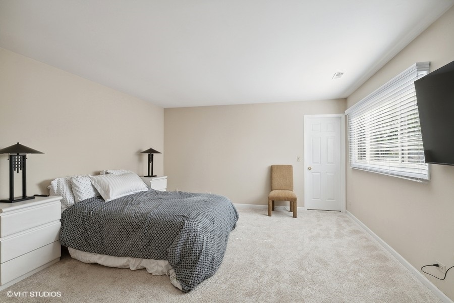 103 Viola Court Rolling Meadows, IL 60008 - Photo 15 of 27 a bedroom with a bed and chair