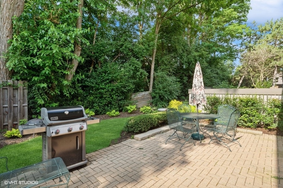 103 Viola Court Rolling Meadows, IL 60008 - Photo 20 of 27 a backyard of a house with a garden and outdoor seating
