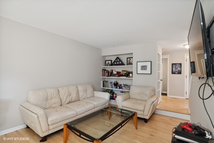 103 Viola Court Rolling Meadows, IL 60008 - Photo 7 of 27 a living room with furniture and a flat screen tv