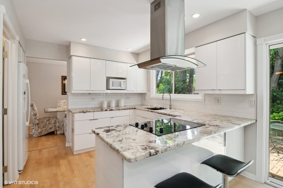 103 Viola Court Rolling Meadows, IL 60008 - Photo 8 of 27 a kitchen with a sink a stove and white cabinets