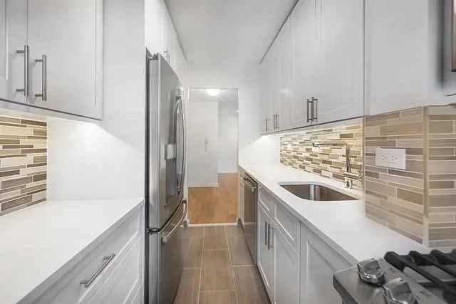 a kitchen with a refrigerator and a sink