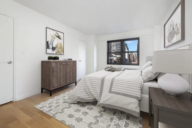 a bedroom with a bed and a window