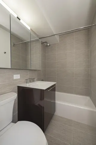 a bedroom with a bed and painting on the wall