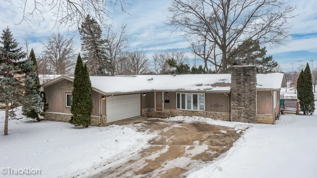a view of a white house with a large tree