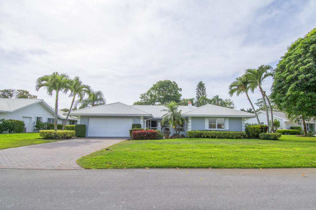 3372 Southeast Court Drive Stuart, FL 34997 - Photo 1 of 33 a front view of a house with a yard