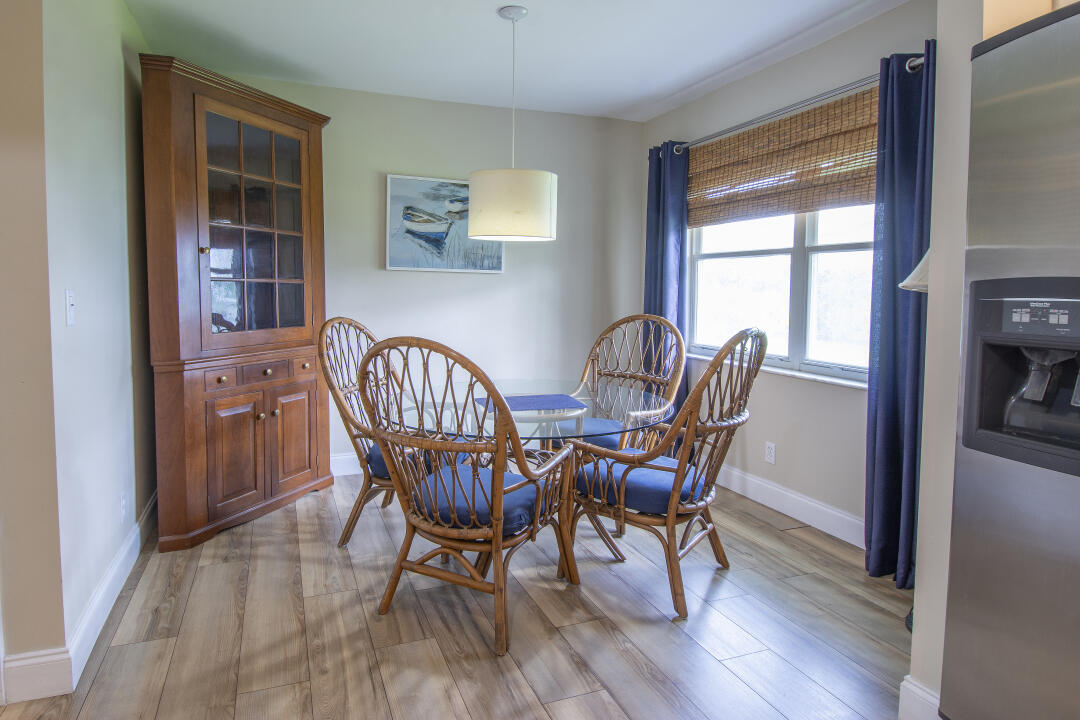 3372 Southeast Court Drive Stuart, FL 34997 - Photo 25 of 33 a view of a dining room with furniture window and wooden floor