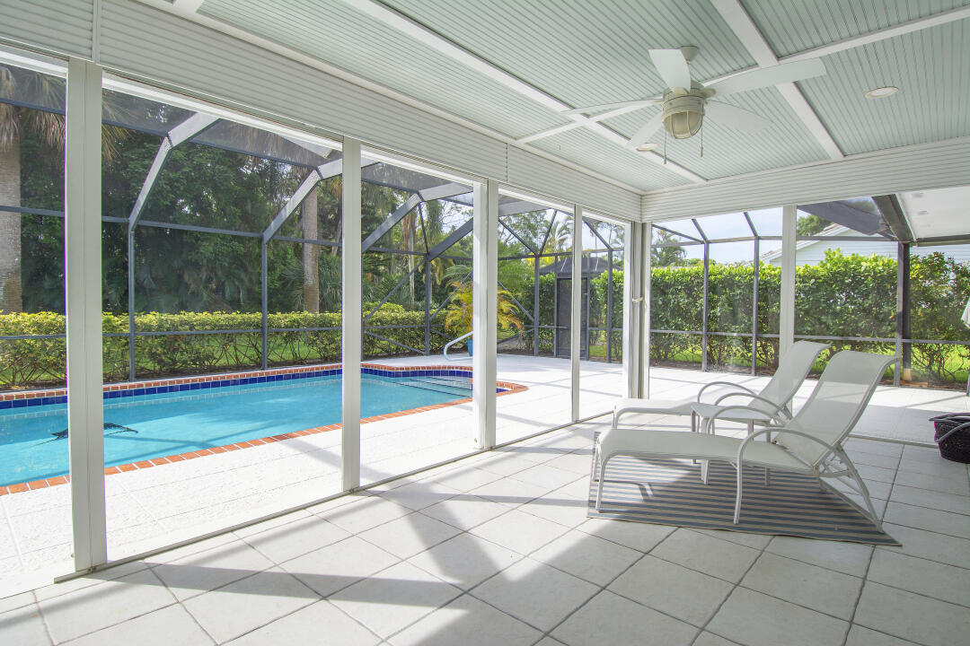 3372 Southeast Court Drive Stuart, FL 34997 - Photo 29 of 33 a living room with glass windows and floor to ceiling window