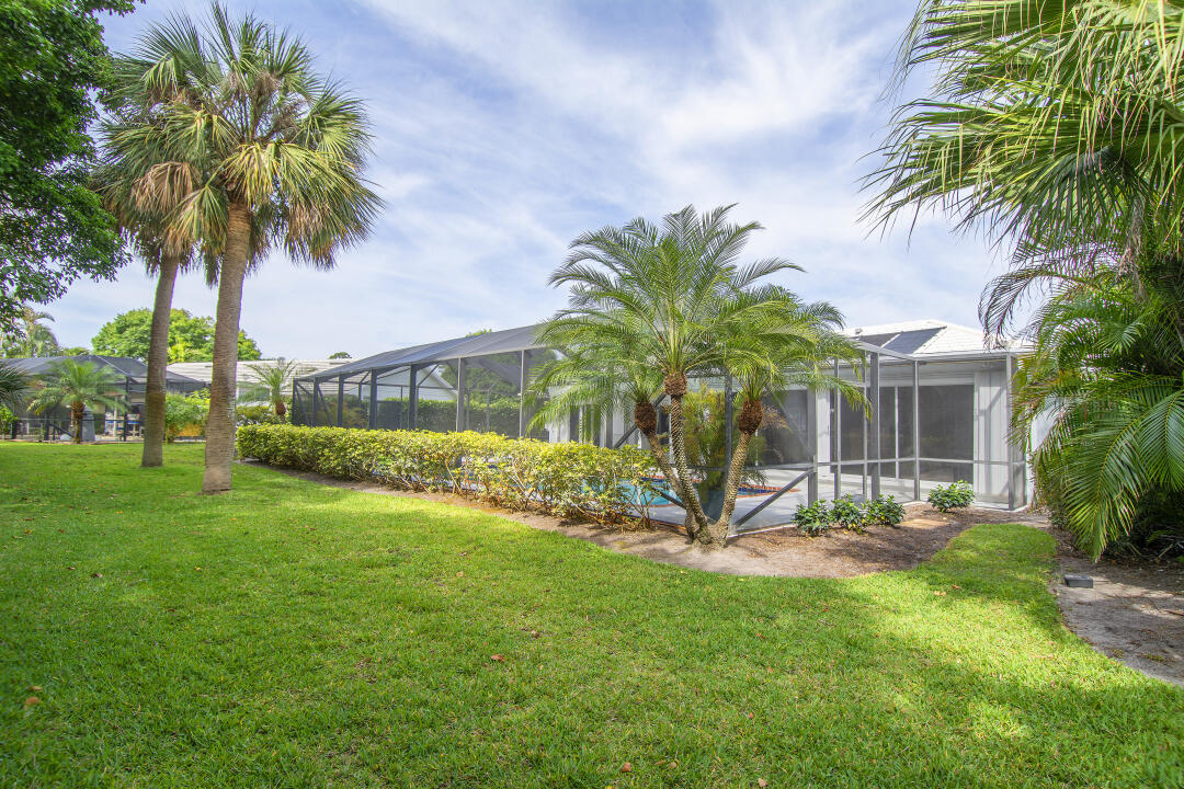 3372 Southeast Court Drive Stuart, FL 34997 - Photo 31 of 33 a view of a backyard with a palm tree